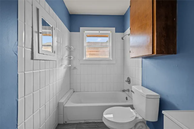 a bathroom with a toilet bathtub and shower