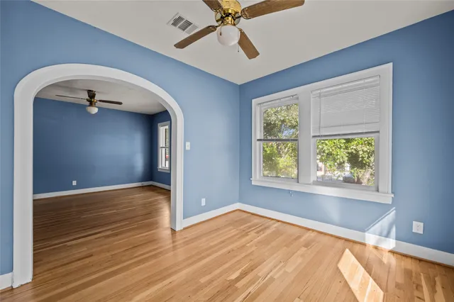 wooden floor in an empty room with a window