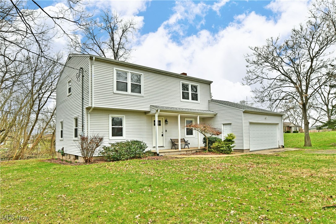 2474 Johnny Cake Road Southeast Warren, OH 44484 - Photo 45 of 50 View of front of house with a chimney, a porch, a garage, and a front lawn