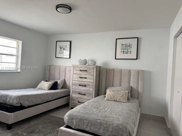 a bedroom with bed and cabinet