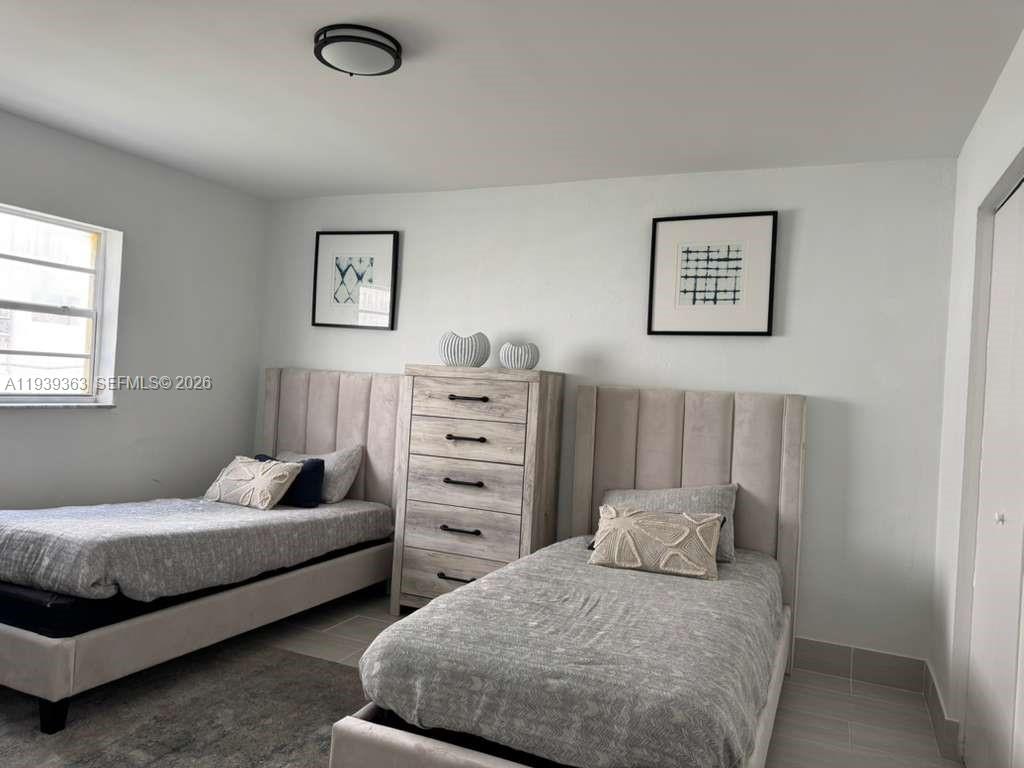 955 West 74th Street, Unit 108 Hialeah, FL 33014 - Photo 4 of 5 a bedroom with bed and cabinet
