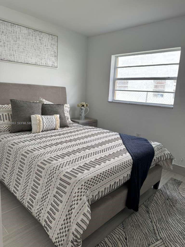 955 West 74th Street, Unit 108 Hialeah, FL 33014 - Photo 5 of 5 a bedroom with a bed and window
