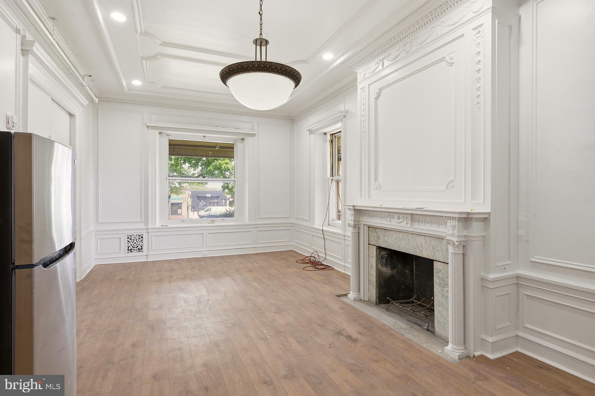 6012 Ridge Avenue, Unit 2 Philadelphia, PA 19128 - Photo 4 of 15 a view of empty room with a fireplace and wooden floor