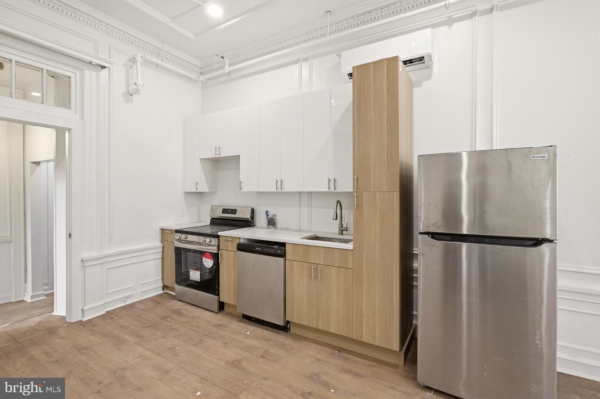 6012 Ridge Avenue, Unit 2 Philadelphia, PA 19128 - Photo 5 of 15 a kitchen with stainless steel appliances a refrigerator sink and cabinets
