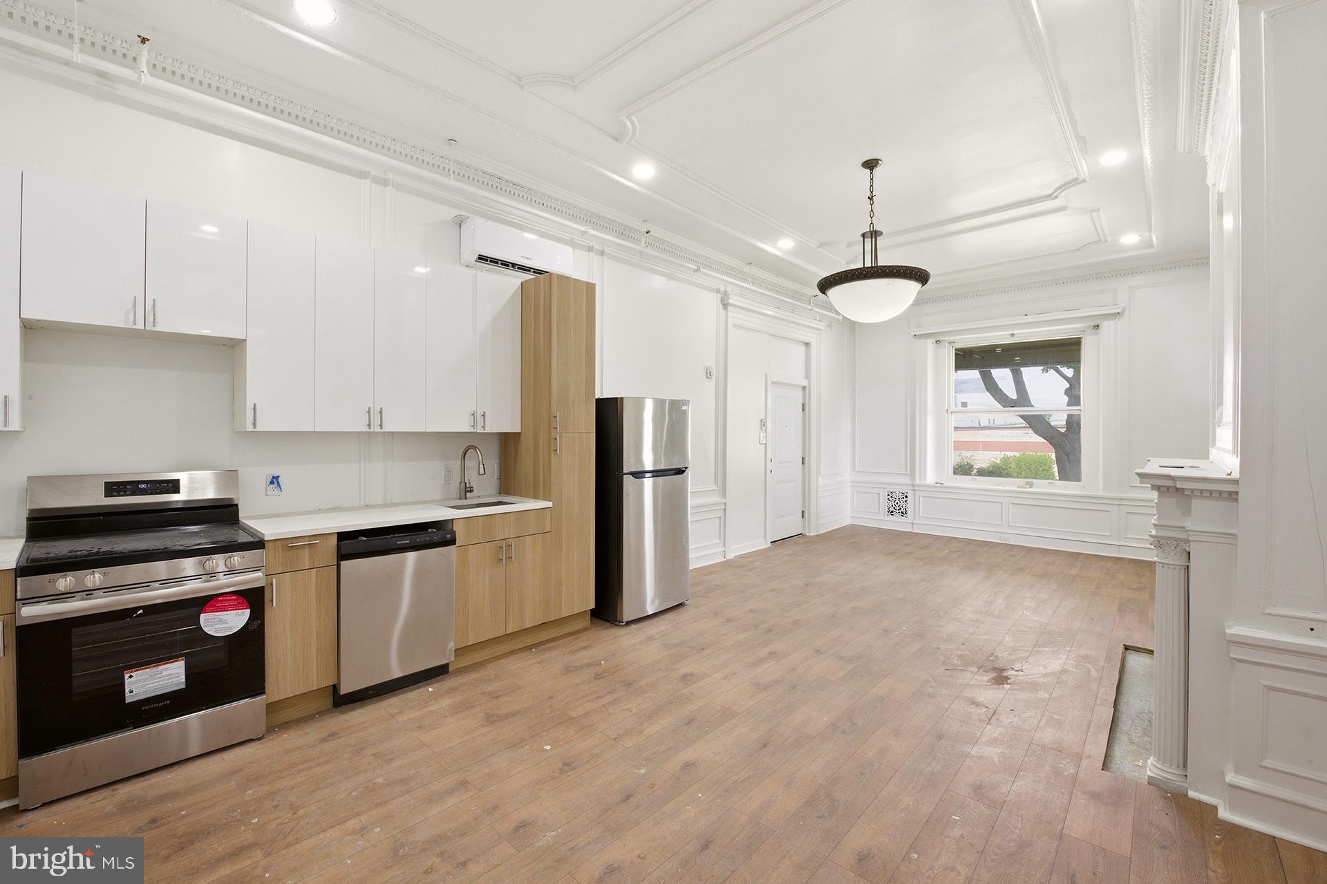 6012 Ridge Avenue, Unit 2 Philadelphia, PA 19128 - Photo 6 of 15 a kitchen with stainless steel appliances granite countertop a stove and a refrigerator