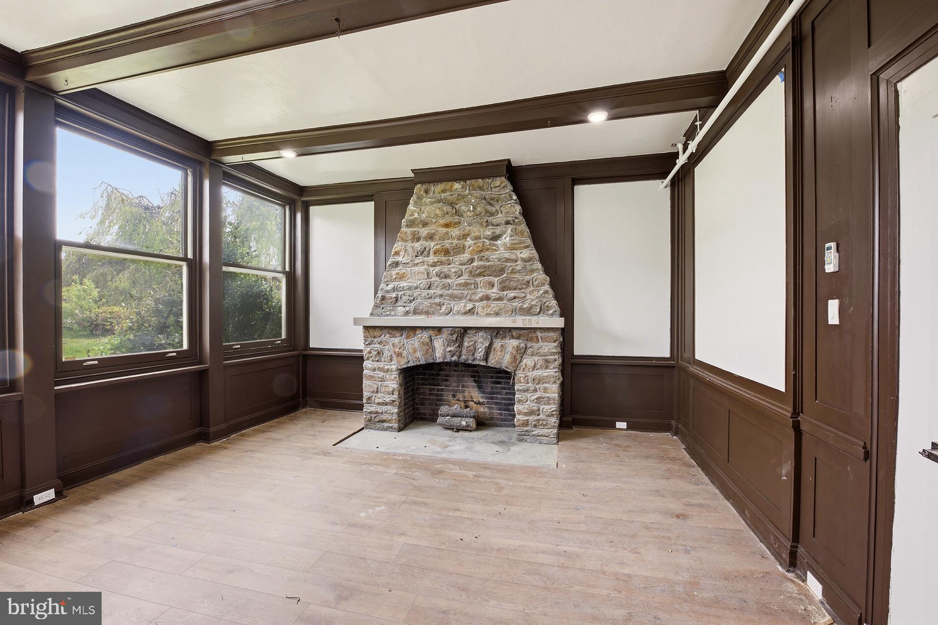 6012 Ridge Avenue, Unit 2 Philadelphia, PA 19128 - Photo 8 of 15 wooden floor fireplace and windows in an empty room