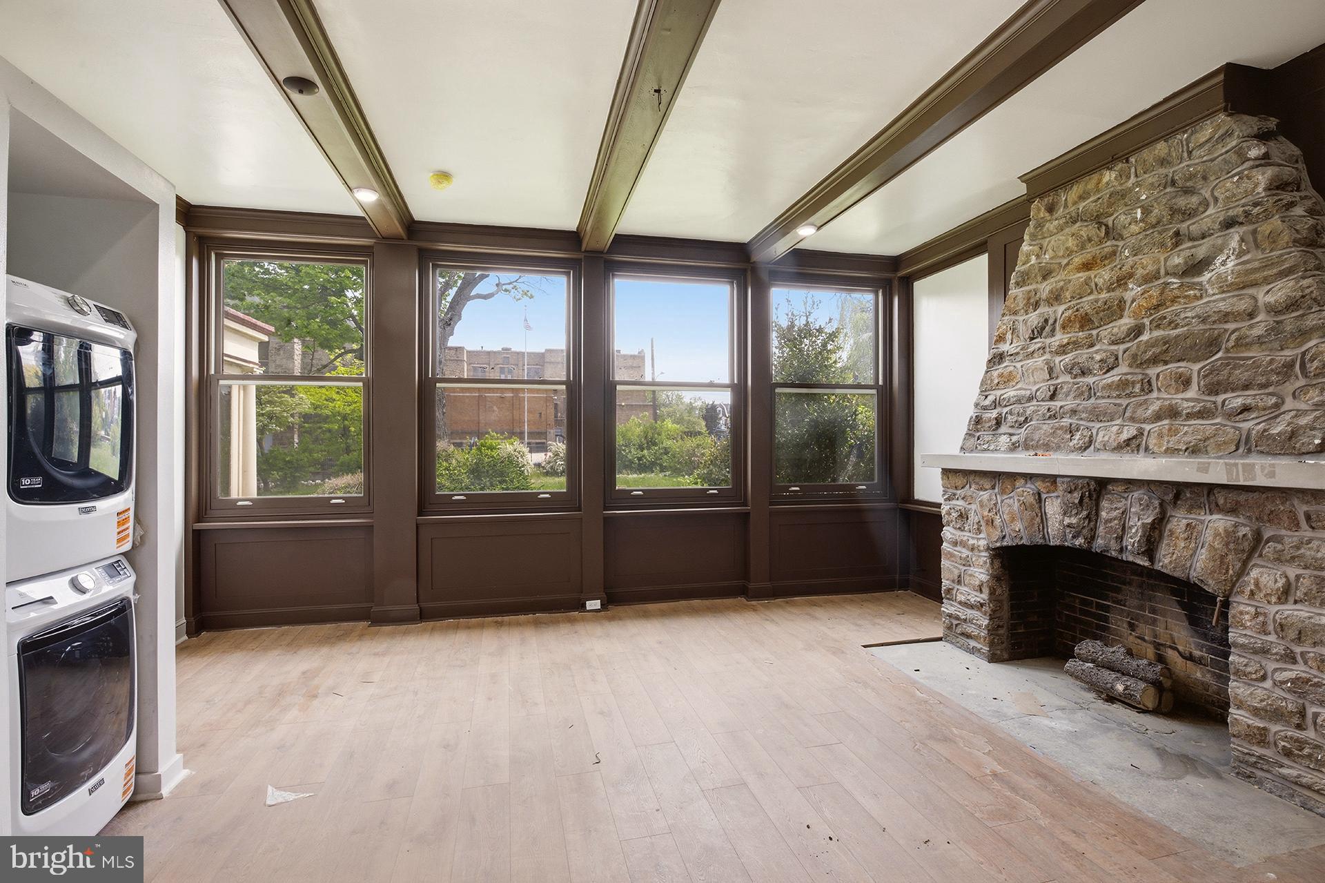 6012 Ridge Avenue, Unit 2 Philadelphia, PA 19128 - Photo 10 of 15 a living room with furniture and a fireplace