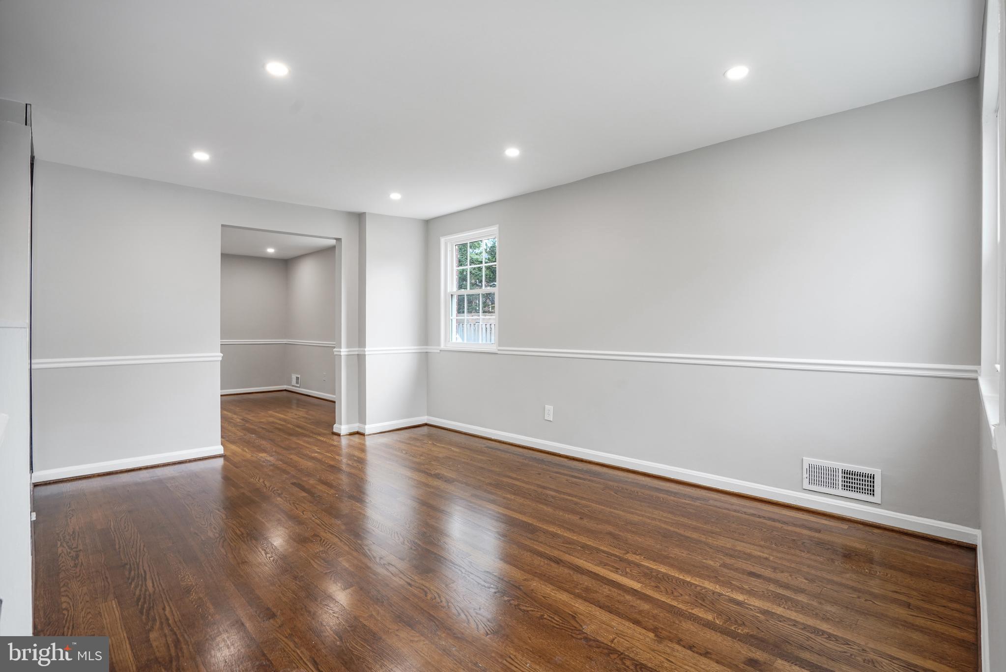 3202 13th Road South Arlington, VA 22204 - Photo 4 of 32 an empty room with wooden floor and windows