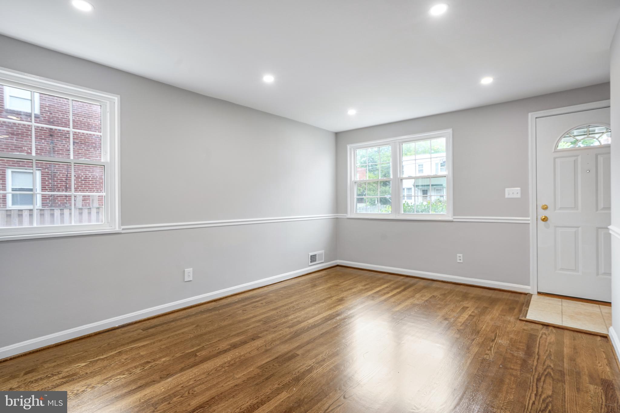 3202 13th Road South Arlington, VA 22204 - Photo 8 of 32 an empty room with wooden floor and windows