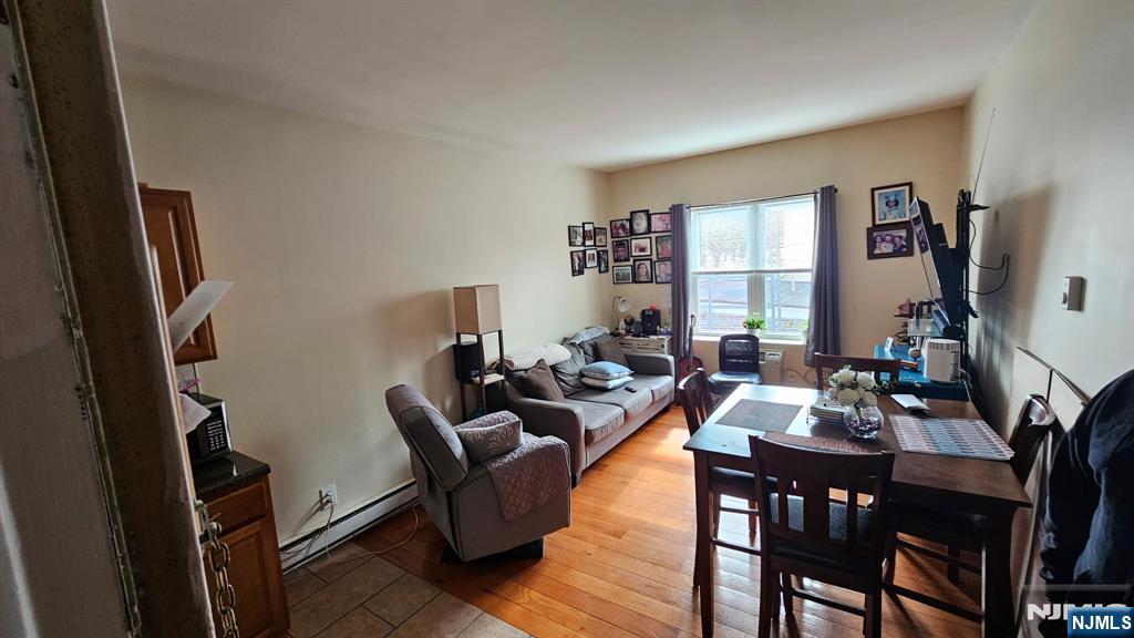467 Hudson Street Hackensack, NJ 07601 - Photo 10 of 13 a living room with furniture a large window and a flat screen tv