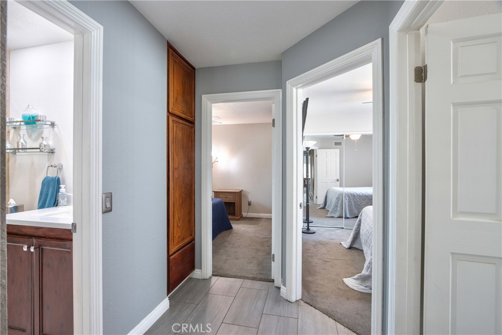 1986 White Rabbit Trail Upland, CA 91784 - Photo 20 of 50 Hallway: second restroom on left hand side, laundry room on right hand side, two bedroom at the end of the hallway