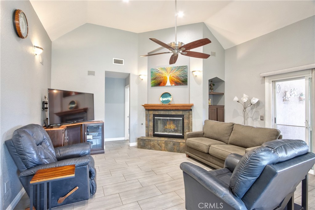 1986 White Rabbit Trail Upland, CA 91784 - Photo 5 of 50 Living room- upon entering the front door. Door next to the fireplace leads to the bedrooms, bathrooms, laundry room and an exterior door. Sliding door on the right hand side leads to the rear yard.