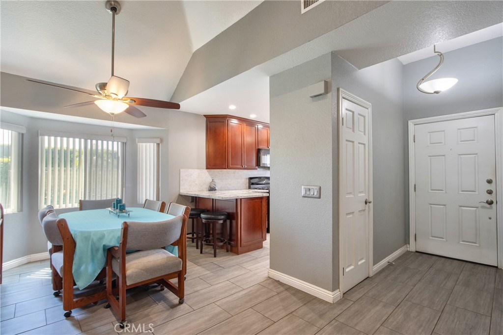 1986 White Rabbit Trail Upland, CA 91784 - Photo 7 of 50 Dining room leading to kitchen. Front door in view with closet in entryway.