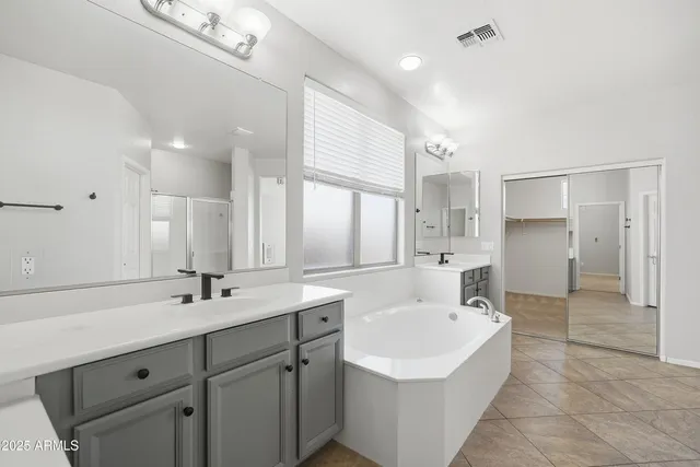 a bedroom with furniture and a chandelier