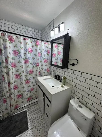 a bathroom with a sink and a mirror with toilet