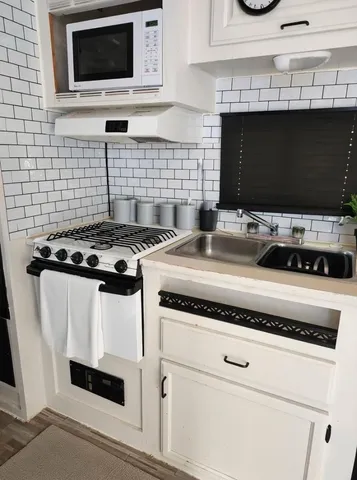 a kitchen with a stove and a microwave