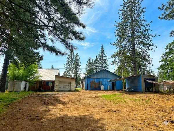 a front view of a house with a yard and wooden fence