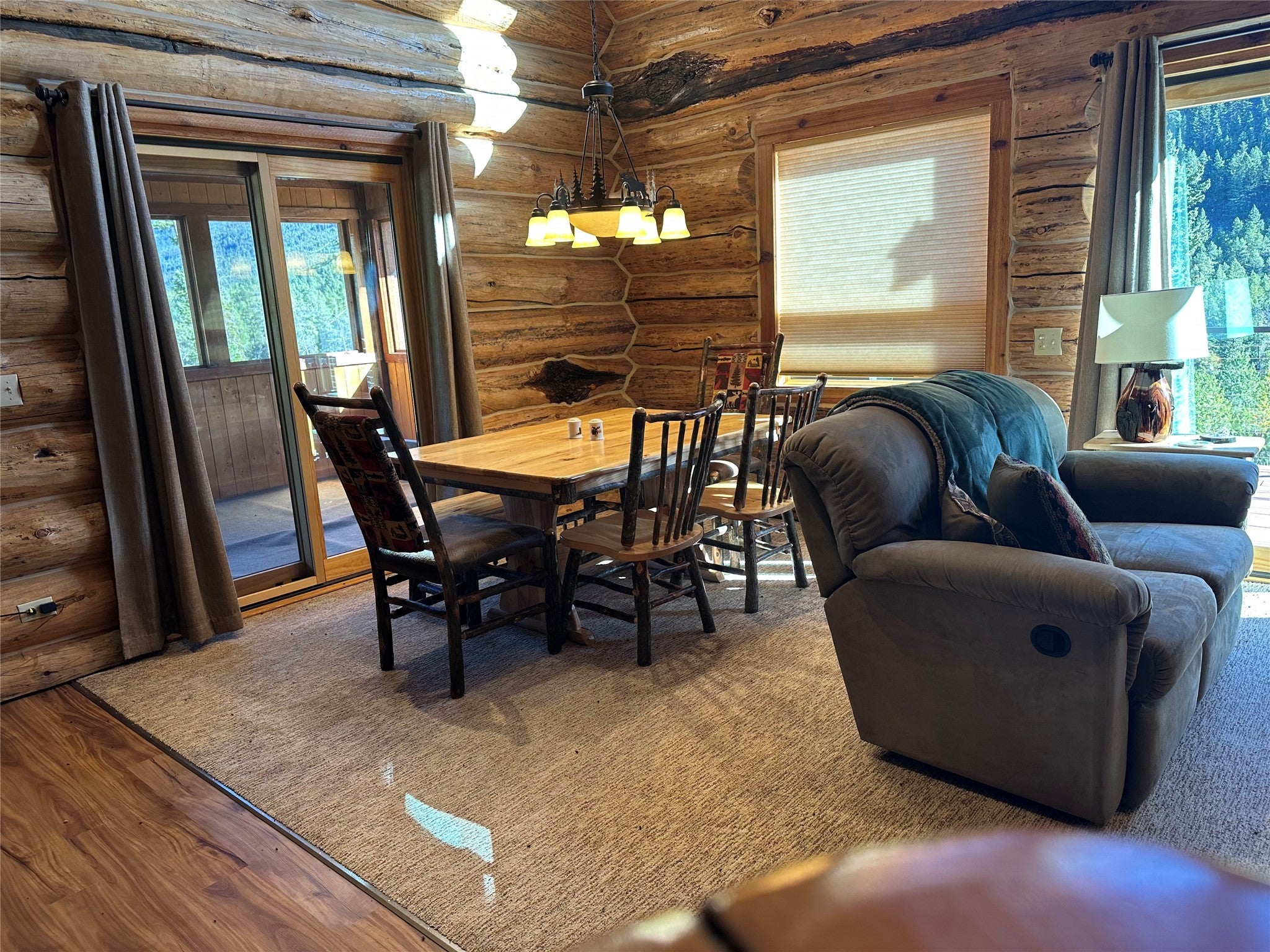 3916 Main Boulder Road McLeod, MT 59052 - Photo 26 of 38 Dining space featuring log walls, wood finished floors, and healthy amount of natural light