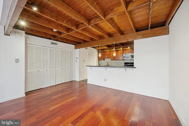 a view of a room with wooden floor