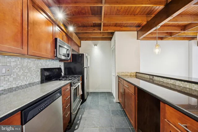 a kitchen with stainless steel appliances granite countertop a stove and a sink