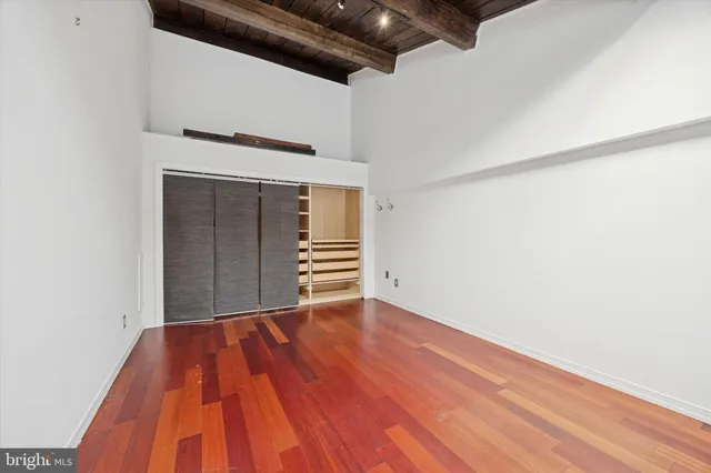 a view of an empty room with wooden floor