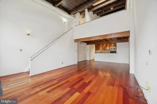 a view of a room with wooden floor
