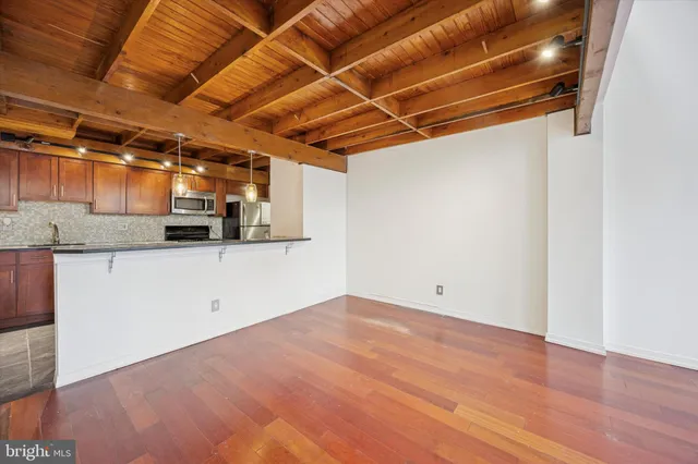 a view of a room with wooden floor