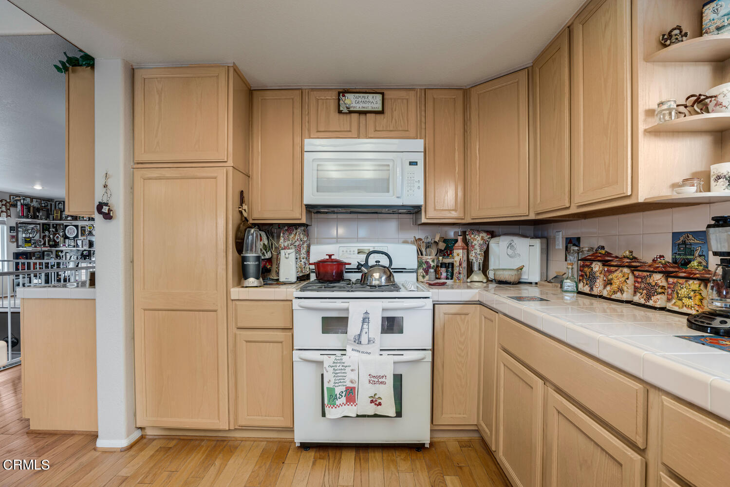 840 Mandalay Beach Road Oxnard, CA 93035 - Photo 14 of 39 a kitchen with stainless steel appliances granite countertop a refrigerator sink stove and cabinets
