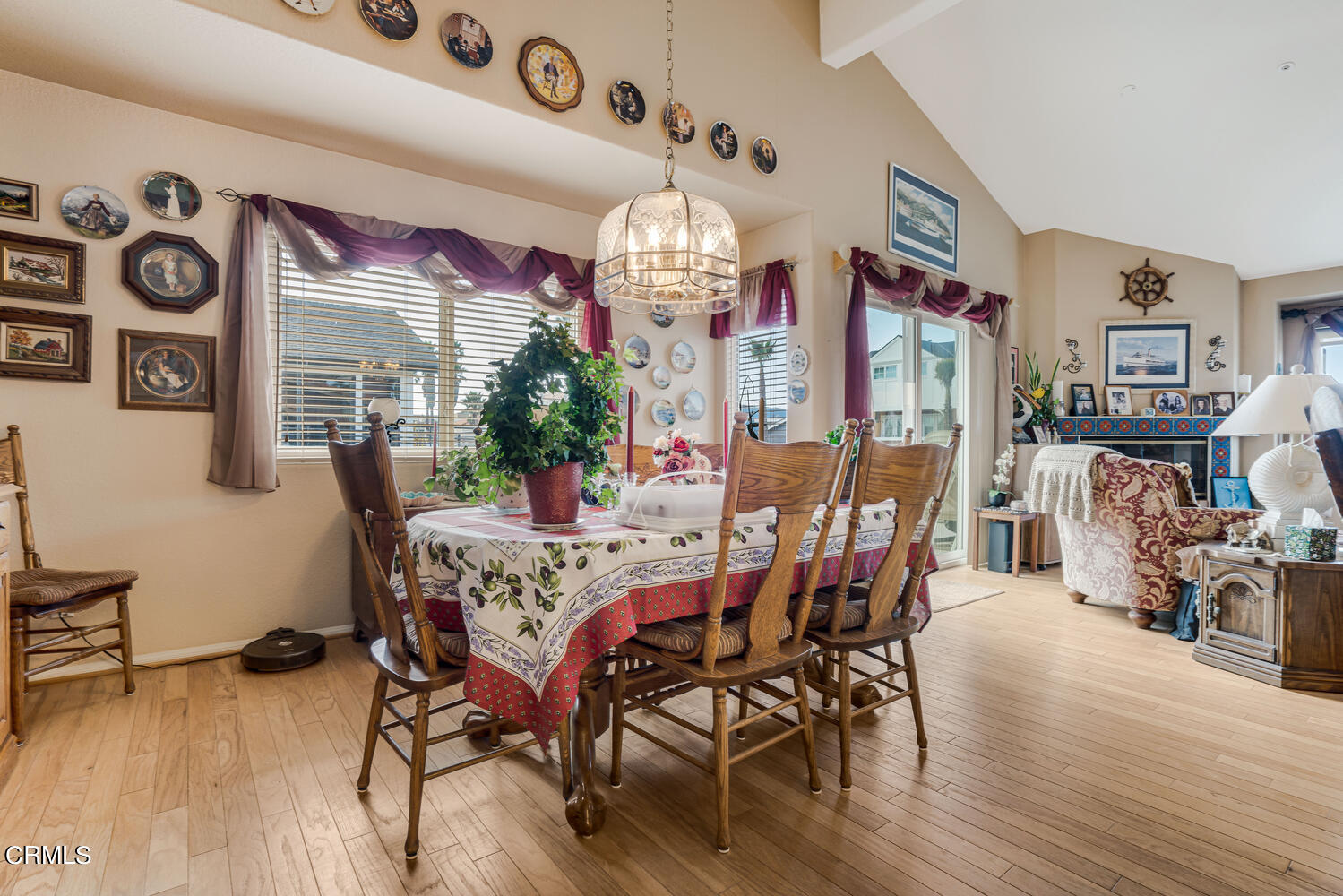 840 Mandalay Beach Road Oxnard, CA 93035 - Photo 15 of 39 a view of a dining room with furniture wooden floor and chandelier