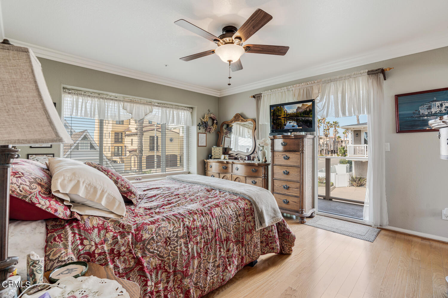 840 Mandalay Beach Road Oxnard, CA 93035 - Photo 22 of 39 a bedroom with a large bed a flat tv screen and a chandelier