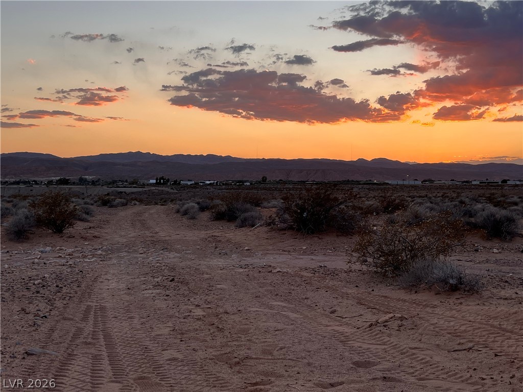 North Ishimoto Overton, NV 89040 - Photo 3 of 10 Witness the captivating desert landscape under a radiant sunset, offering vast potential.