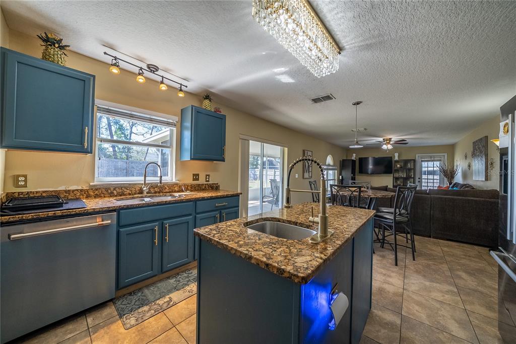 5306 Southwest 115th Street Road Ocala, FL 34476 - Photo 12 of 56 a kitchen with stainless steel appliances granite countertop counter space sink stove and cabinets