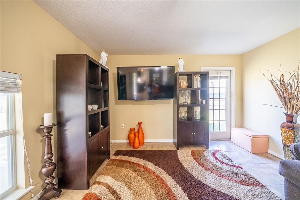 5306 Southwest 115th Street Road Ocala, FL 34476 - Photo 16 of 56 a bedroom with a bed closet and a large window