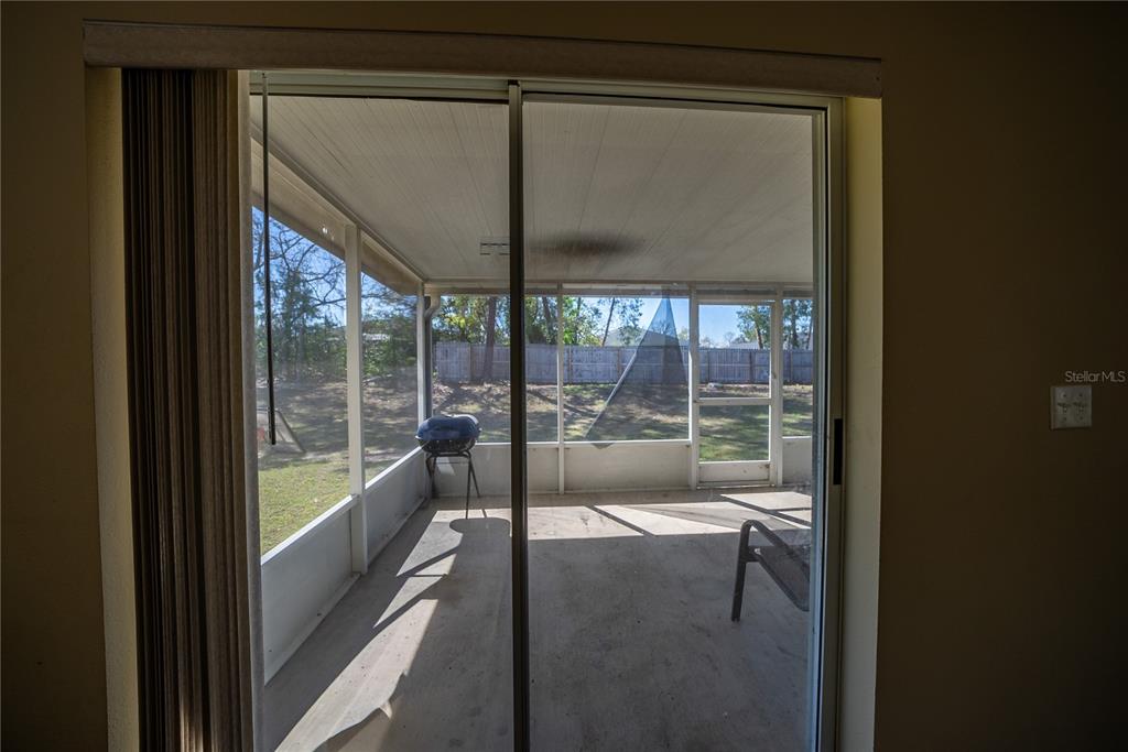 5306 Southwest 115th Street Road Ocala, FL 34476 - Photo 18 of 56 a view of a glass door with a porch