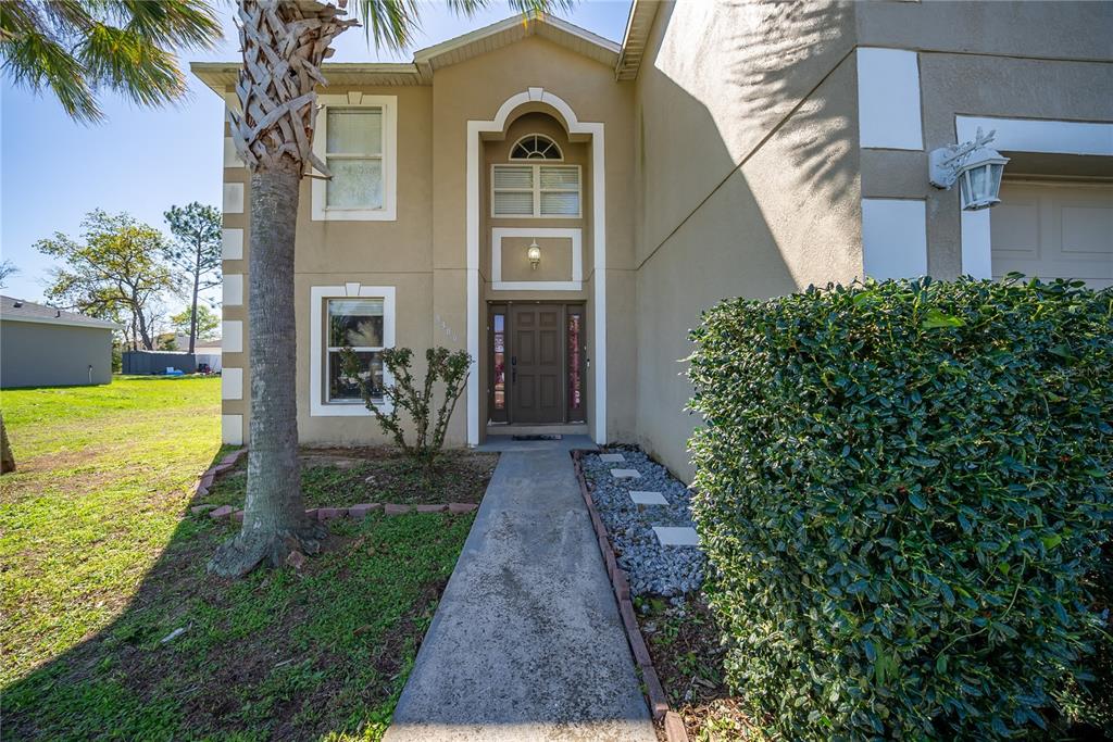 5306 Southwest 115th Street Road Ocala, FL 34476 - Photo 2 of 56 a front view of a house with a yard