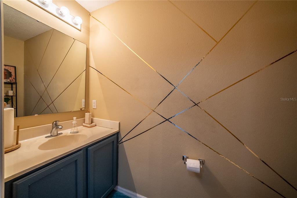 5306 Southwest 115th Street Road Ocala, FL 34476 - Photo 23 of 56 a bathroom with a sink and a mirror