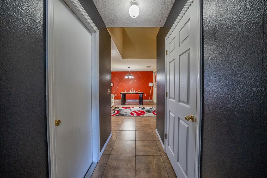 5306 Southwest 115th Street Road Ocala, FL 34476 - Photo 25 of 56 a view of a hallway with a dining table and chairs