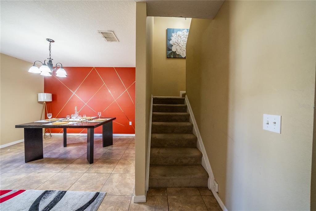 5306 Southwest 115th Street Road Ocala, FL 34476 - Photo 27 of 56 a view of entryway kitchen and hall with wooden floor