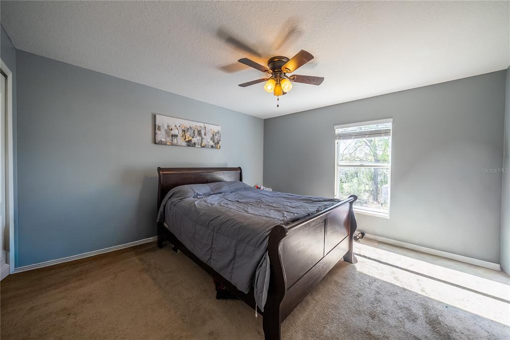5306 Southwest 115th Street Road Ocala, FL 34476 - Photo 33 of 56 a bedroom with a bed and a window