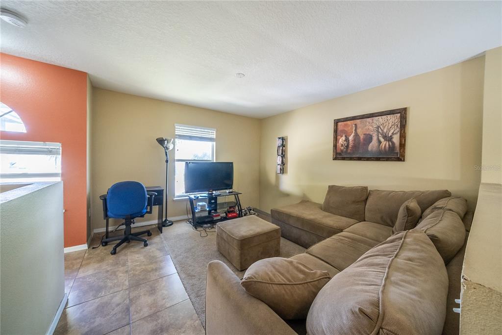 5306 Southwest 115th Street Road Ocala, FL 34476 - Photo 34 of 56 a living room with furniture and a chair