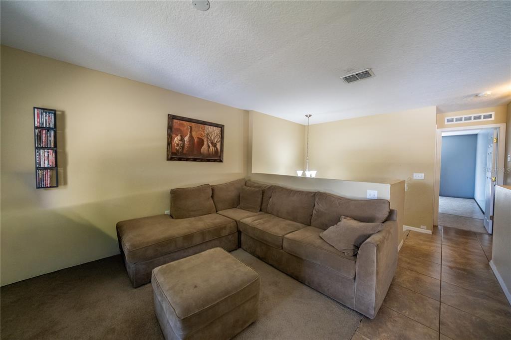 5306 Southwest 115th Street Road Ocala, FL 34476 - Photo 35 of 56 a living room with furniture and a couch
