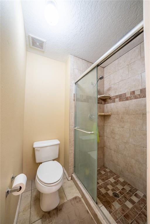 5306 Southwest 115th Street Road Ocala, FL 34476 - Photo 40 of 56 a bathroom with a toilet and a shower