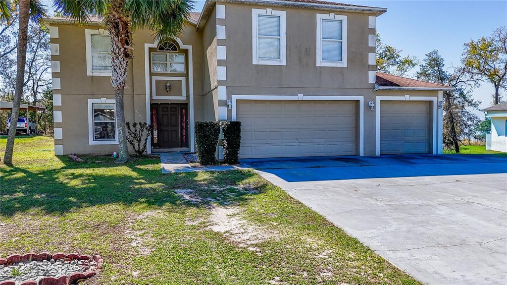 5306 Southwest 115th Street Road Ocala, FL 34476 - Photo 48 of 56 a view of a house with a small yard and plants