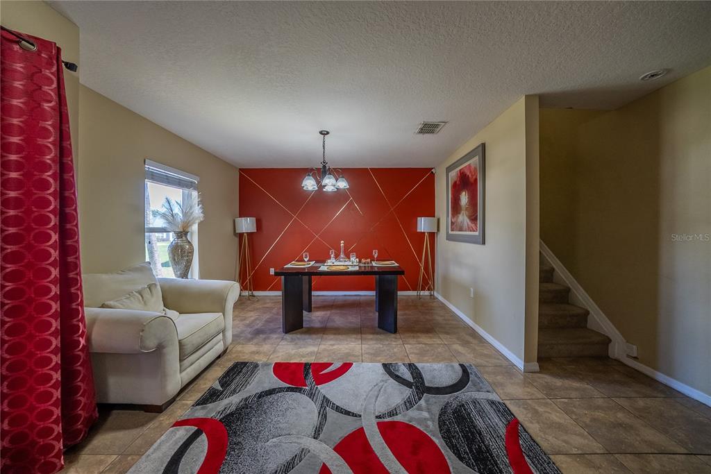 5306 Southwest 115th Street Road Ocala, FL 34476 - Photo 5 of 56 a living room with furniture and a wooden floor