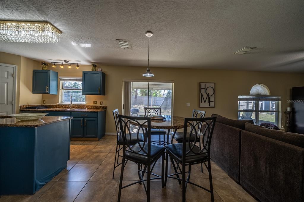 5306 Southwest 115th Street Road Ocala, FL 34476 - Photo 10 of 56 a view of a dining room with furniture and a chandelier