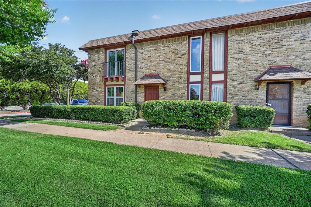 1801 East Grauwyler Road, Unit 101 Irving, TX 75061 - Photo 3 of 39 a front view of a house with a yard