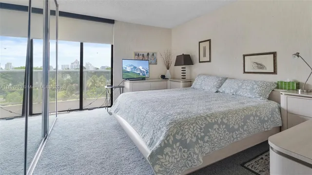a bedroom with a large bed and a balcony view