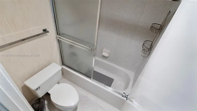 a white toilet sitting next to a shower