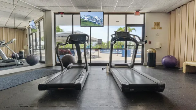a room with gym equipment and a large window