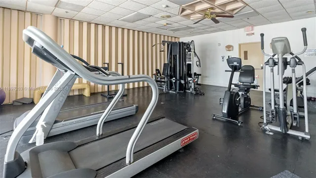 a living room with furniture and a book shelf
